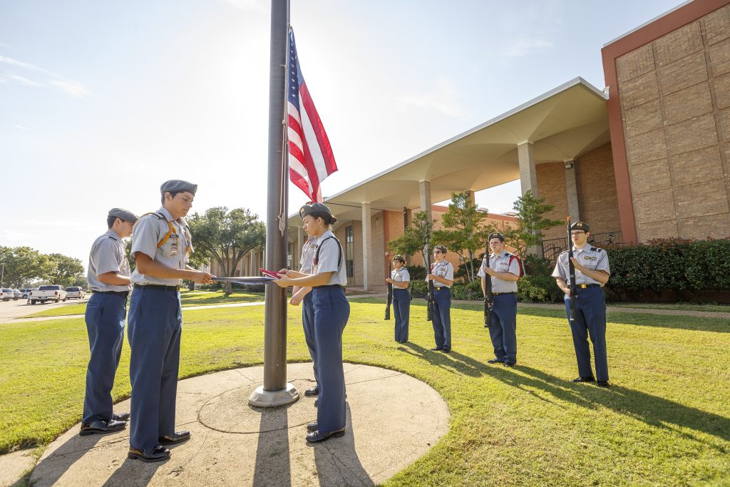 ROTC students putting up US flag