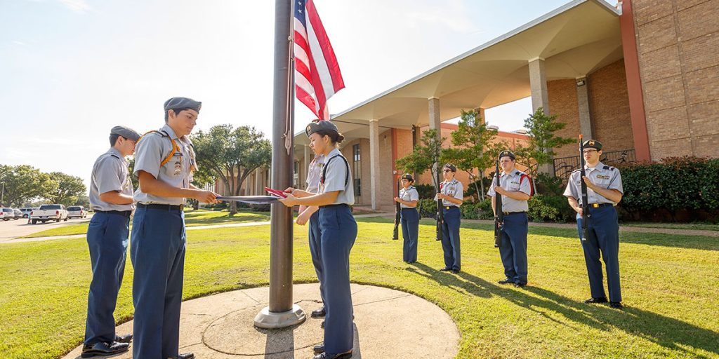 ROTC students putting up US flag