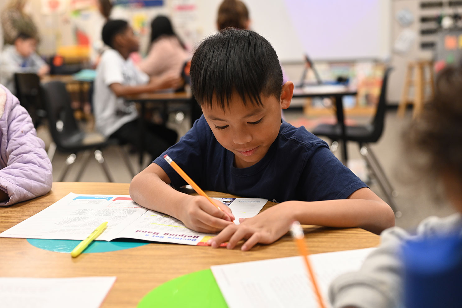 Student writing in classroom