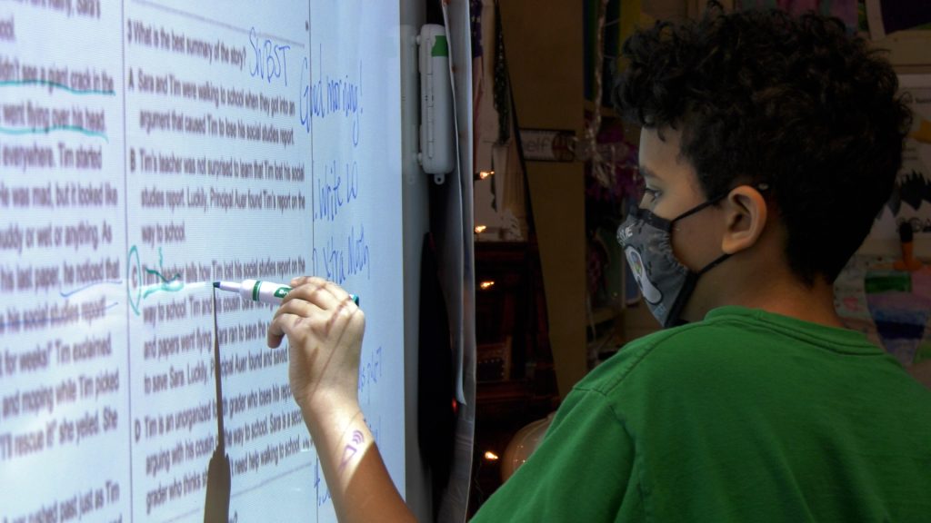 Keeping Tabs student working at the white board