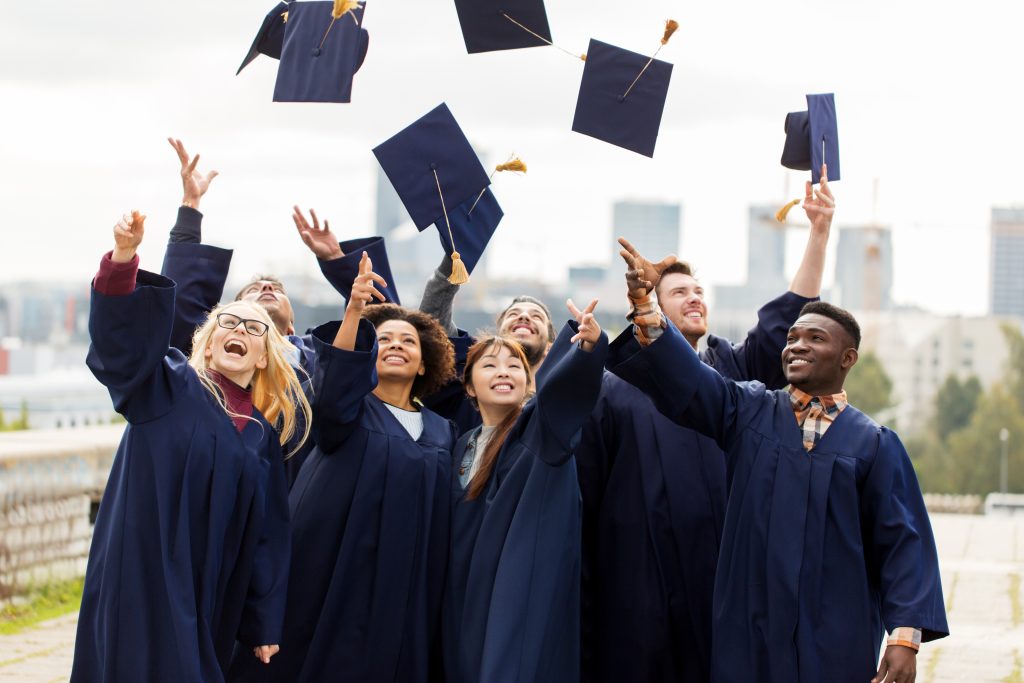 graduates throwing caps in the air
