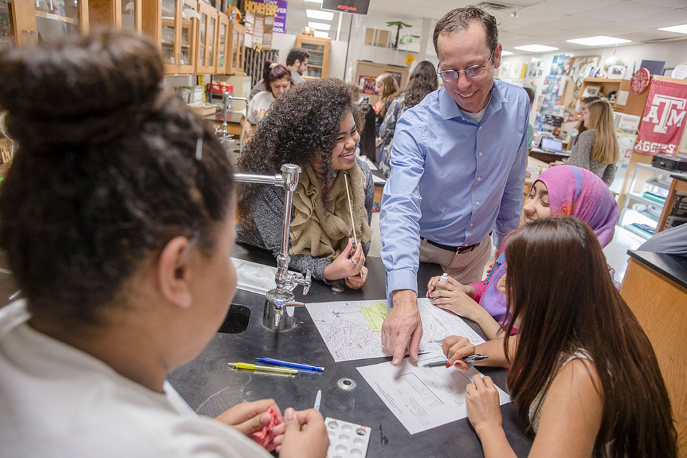 Science teacher working with students