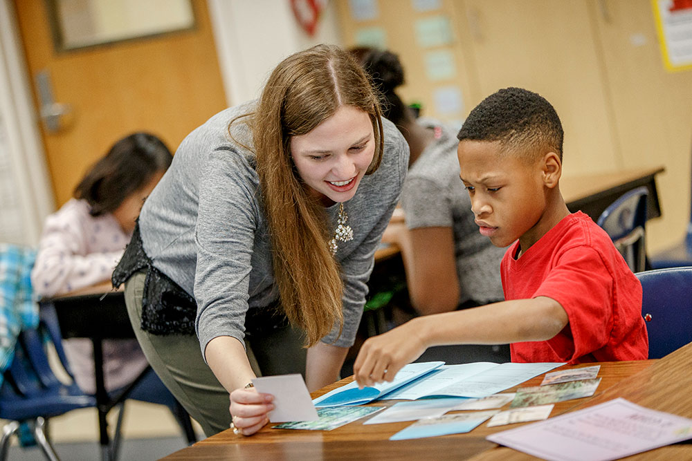 Teacher working with student with cards