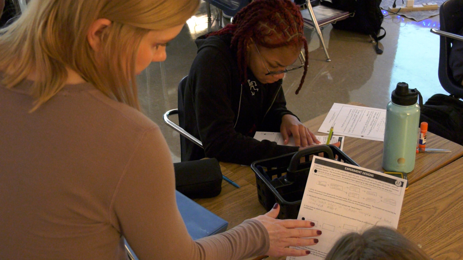 Image of classroom teacher assisting student