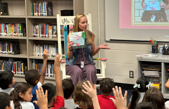OHenry Teacher with Students reading book, The Smallest Pig