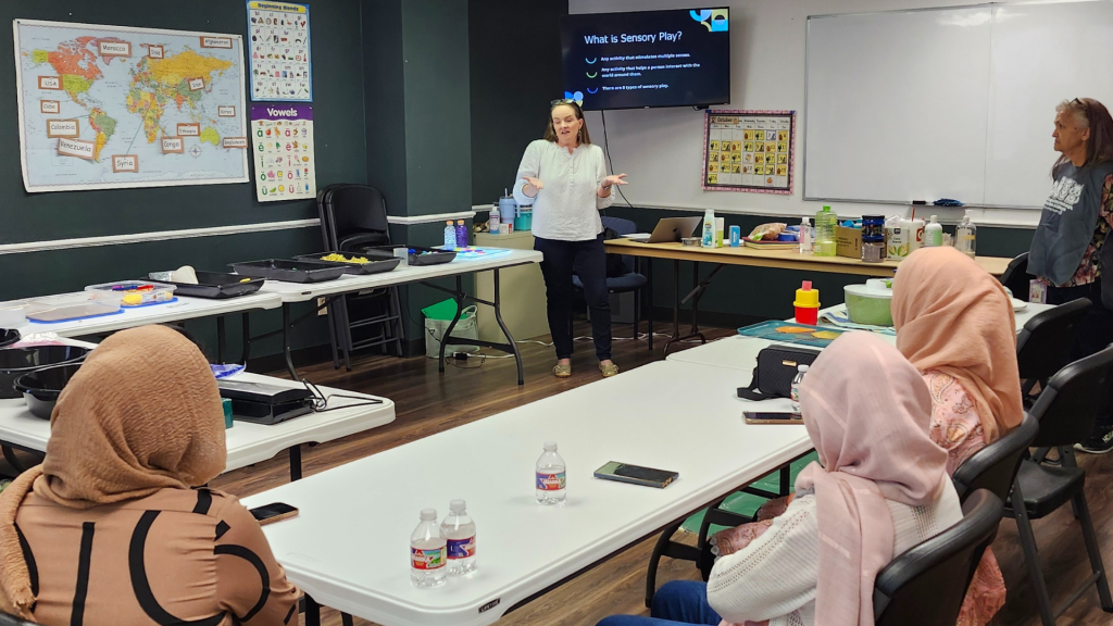 Gateway of grace students with early childhood learning teacher around table