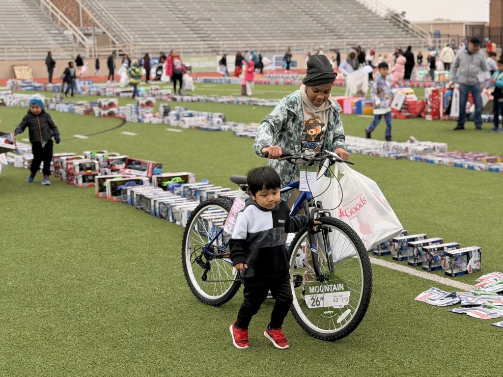 student with bike on the field