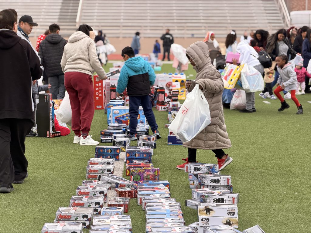student with bag choosing from toys on field