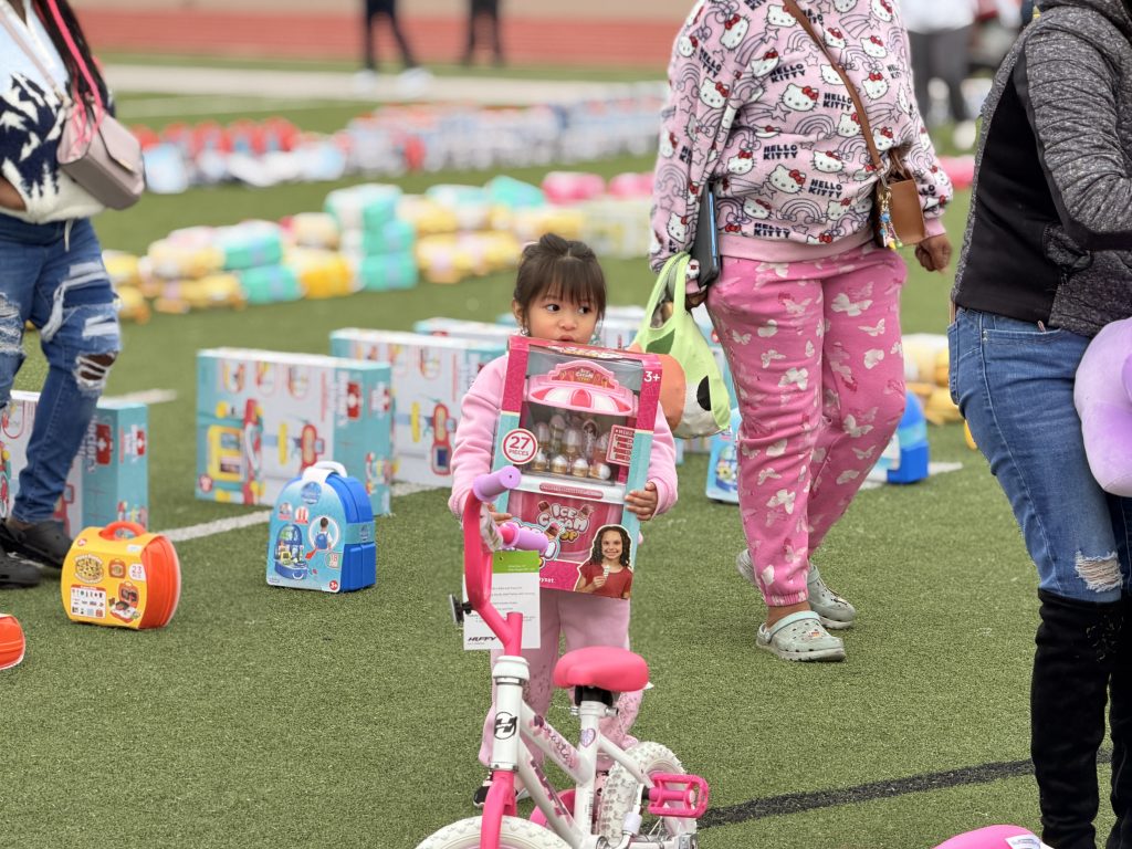 Toddler with toy and bike