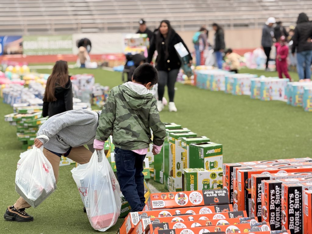 Student walking down field filled with toys