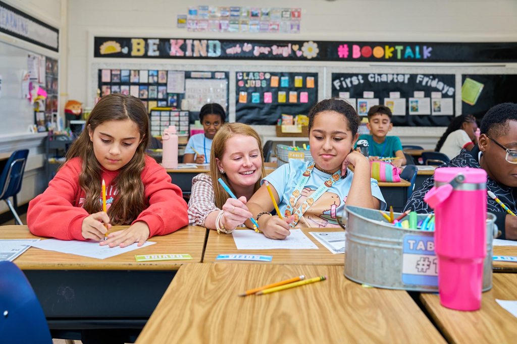 Teacher working with students