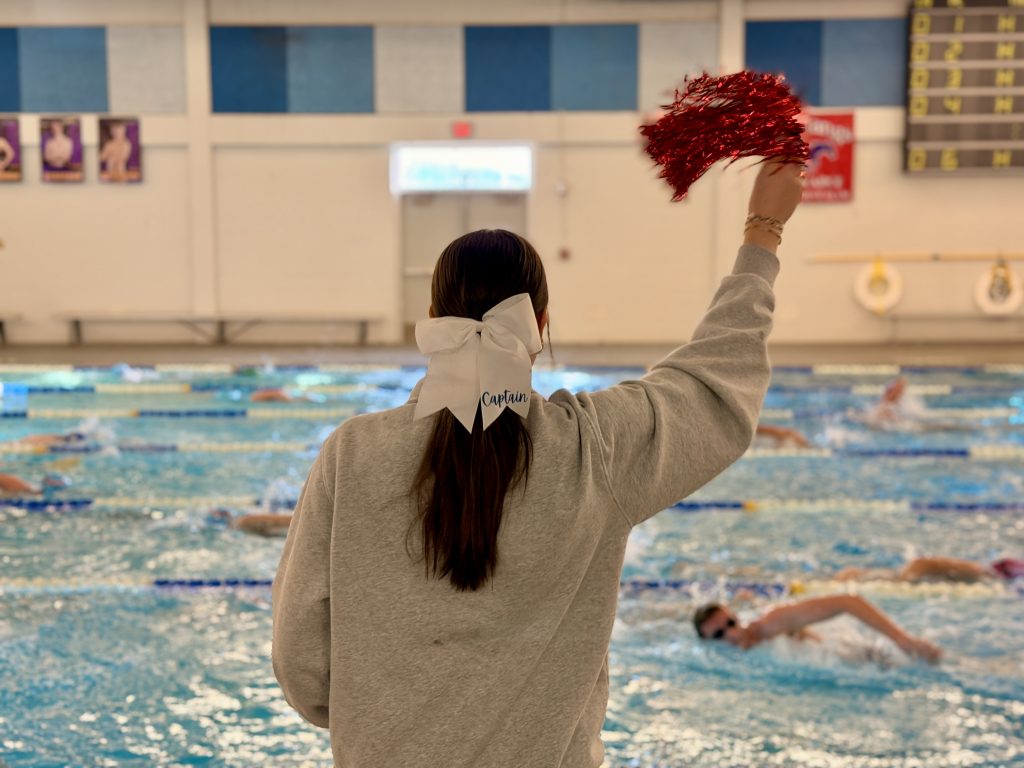 student cheering swimmers on