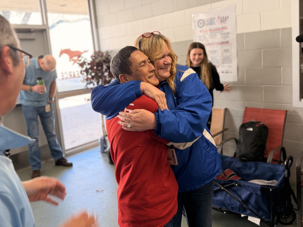 Principal Carrie Breedlove embracing Mr. Le