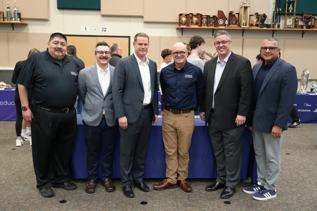 Group of staff posing in band hall
