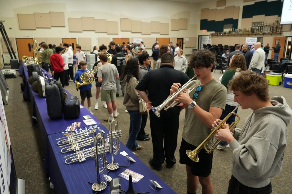 Students testing trumpets