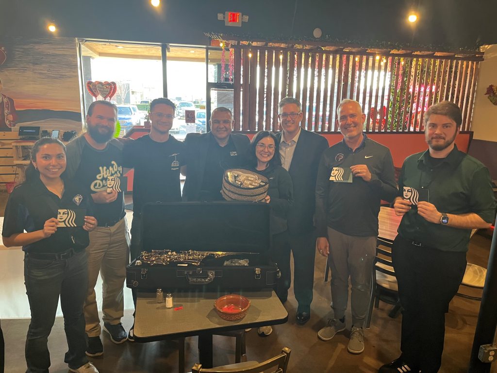 Prize winners with prizes and Conn Selmer Associates