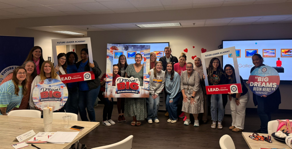 Group of staff posing with Dream Big posters