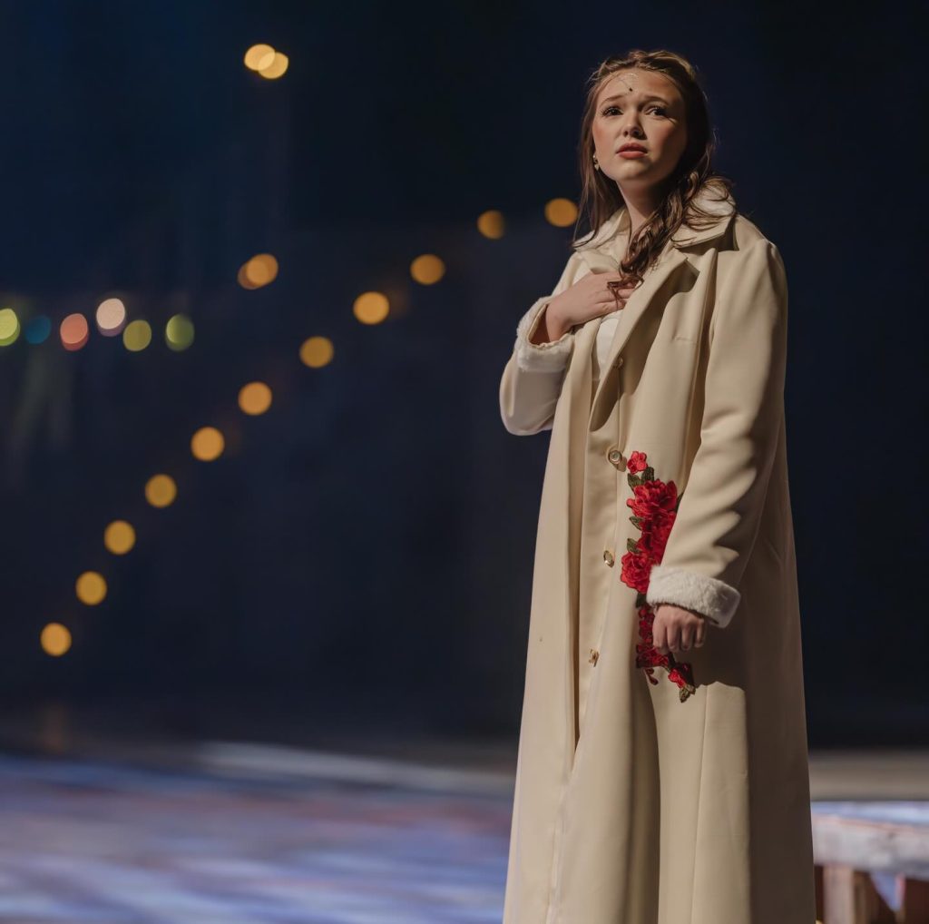 Andie Miller on stage in costume