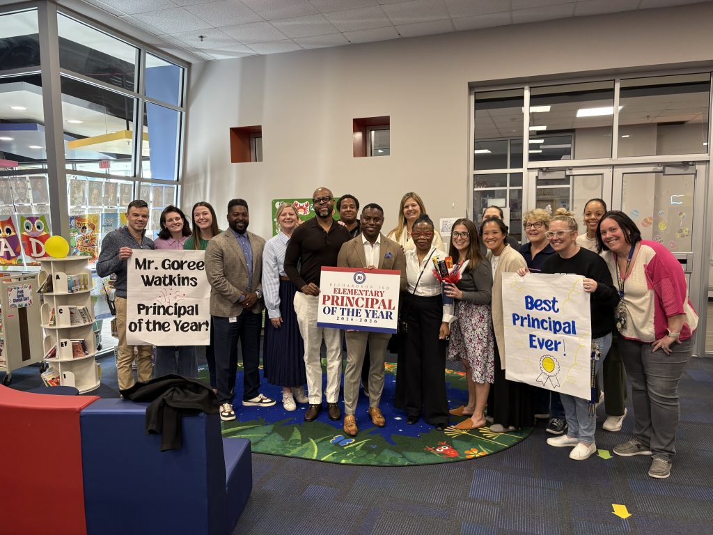 Goree Watkins and team holding POY sign