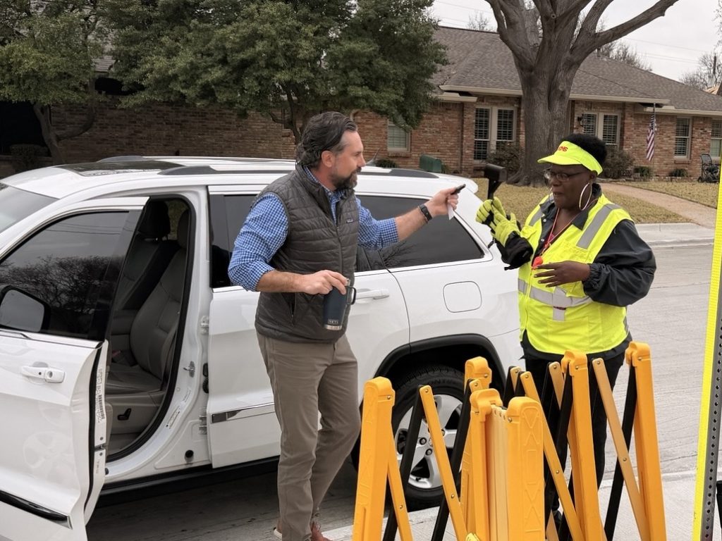 Man handing keys to Ms. Crawford