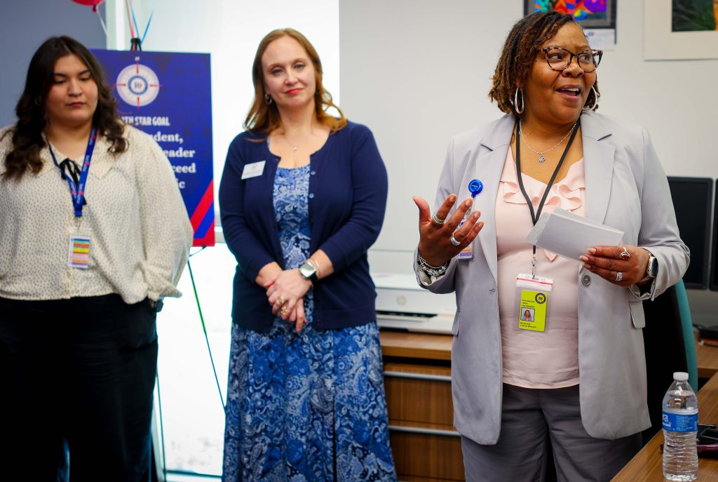woman speaking as two others listen
