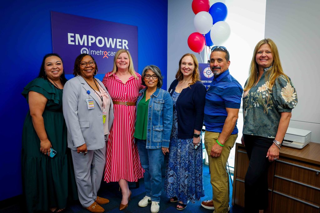 District leadership posing in front of metrocare sign