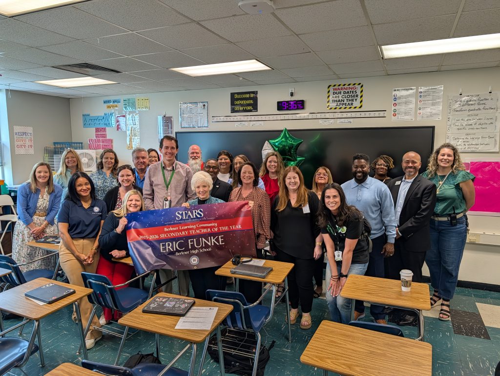 Eric Funke - BHS holding STARS teacher sign, big check, surrounded by prize patrol
