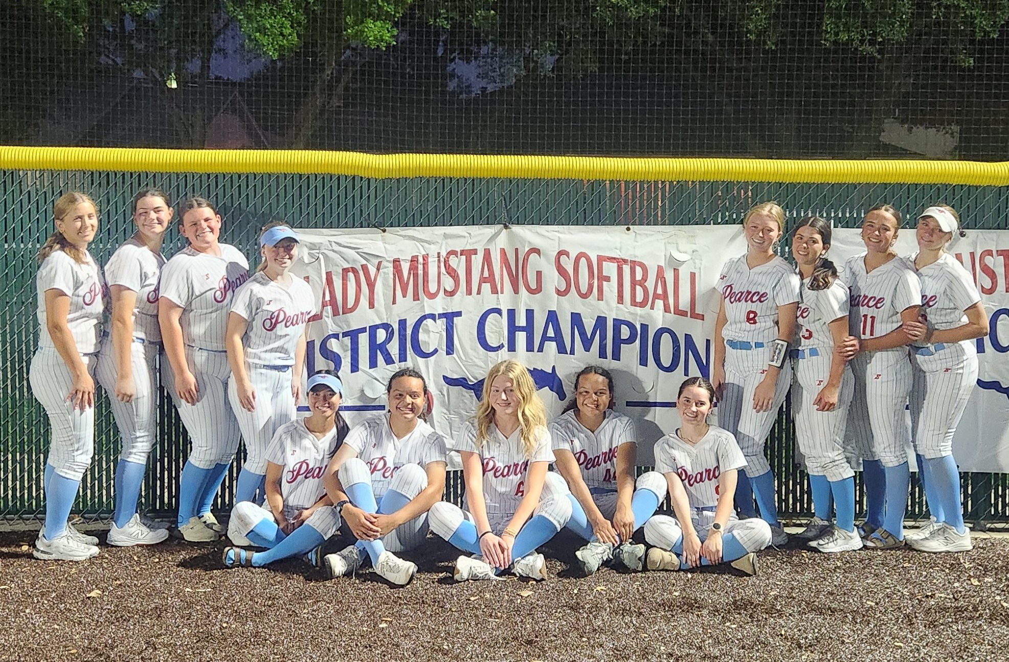 Pearce HS Softball team in front of District Champions sign on the field