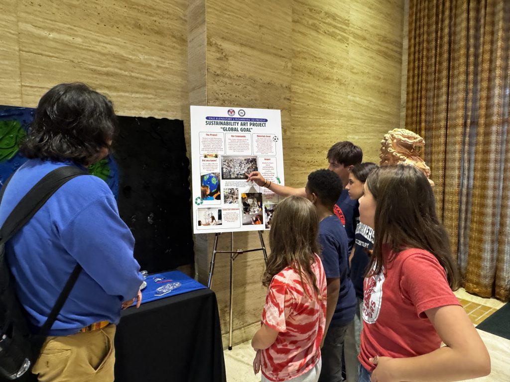 Students explaining to onlooker about the process