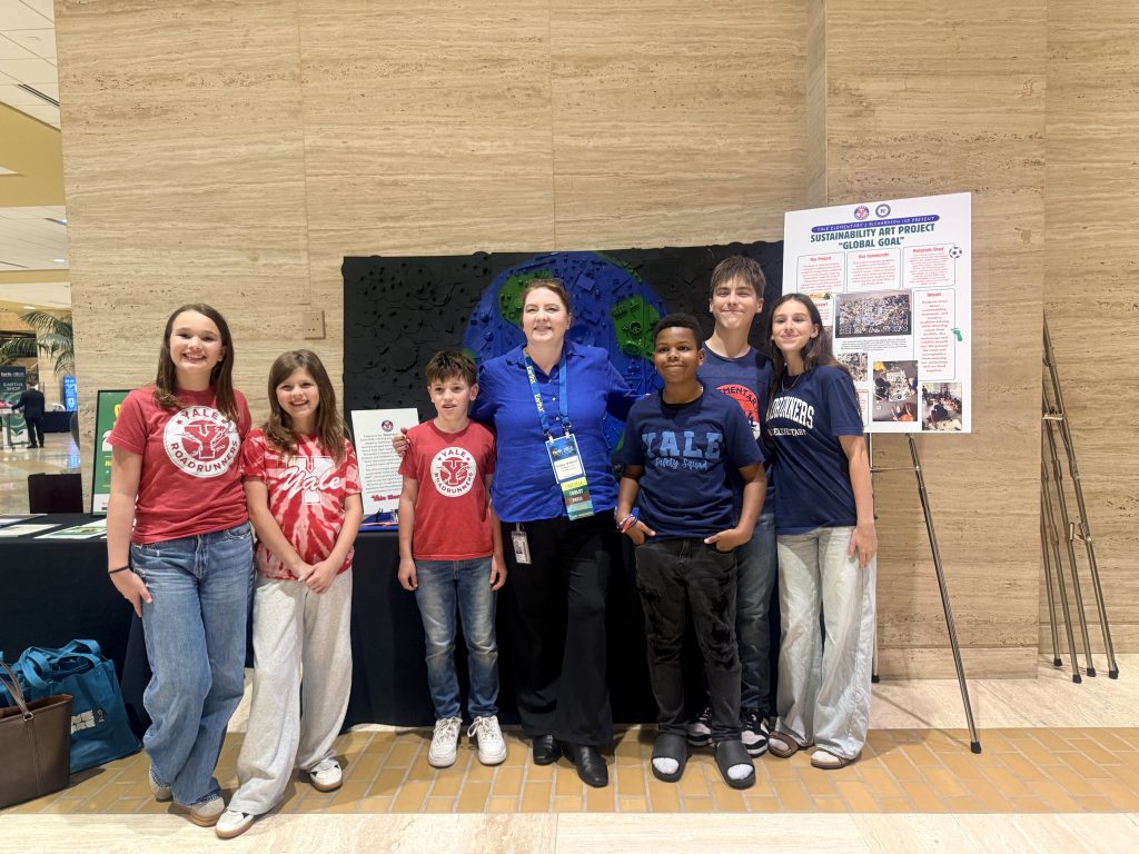 yale students posing in front of artwork at the conference