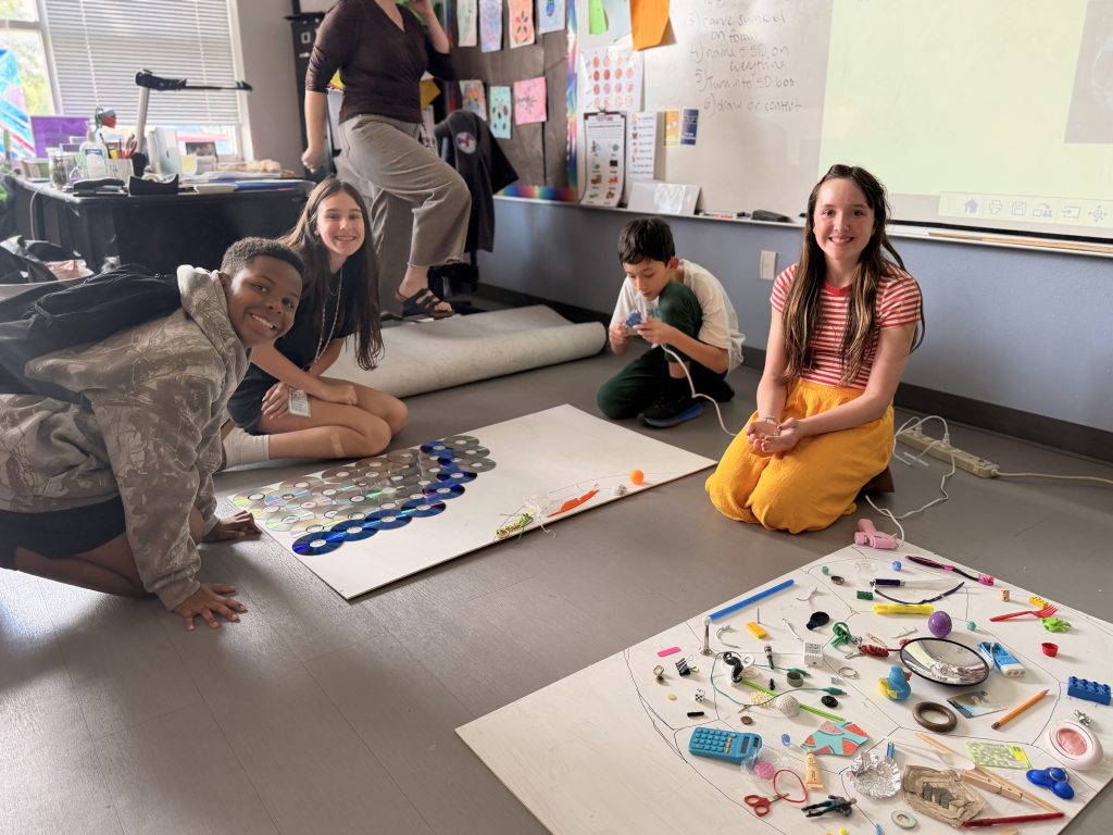 students in art club working on pieces of the found object art project