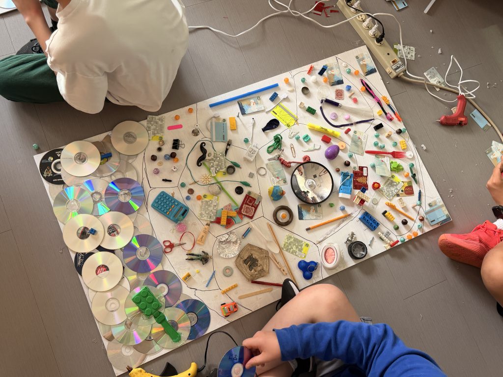 Art in progress - Found objects placed on board on the floor