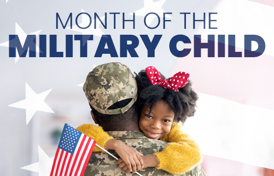 Month of the Military Child: Child hugging army dad holding american flag