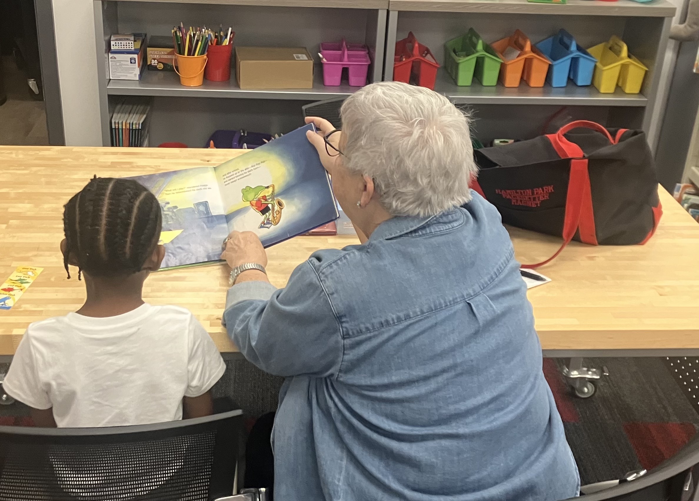 woman reading to student