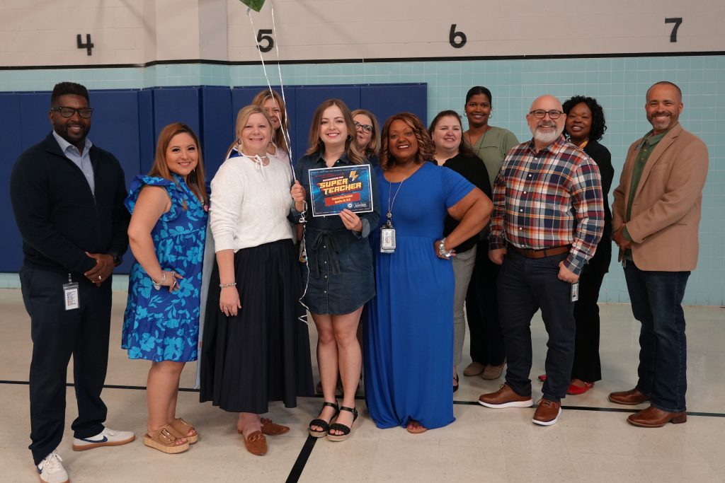 Super Teacher from Apollo Junior High Samantha Conlon posing with district and campus admin holding certificate and balloons