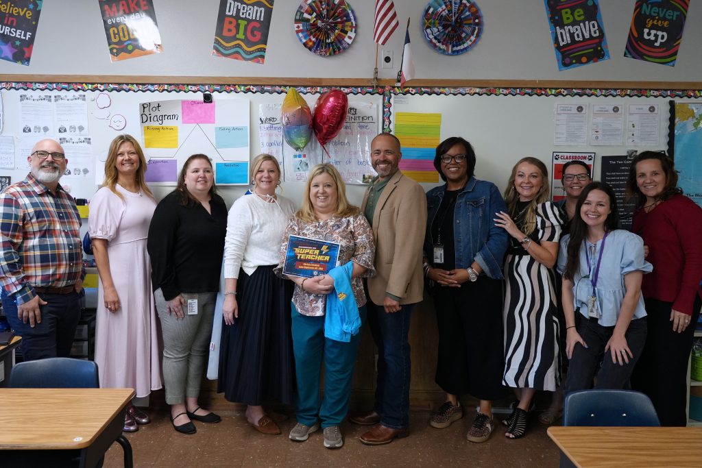 Super Teacher from Lake Highlands High School Christy Strahan posing district and campus admin holding certificate and balloons in classroom