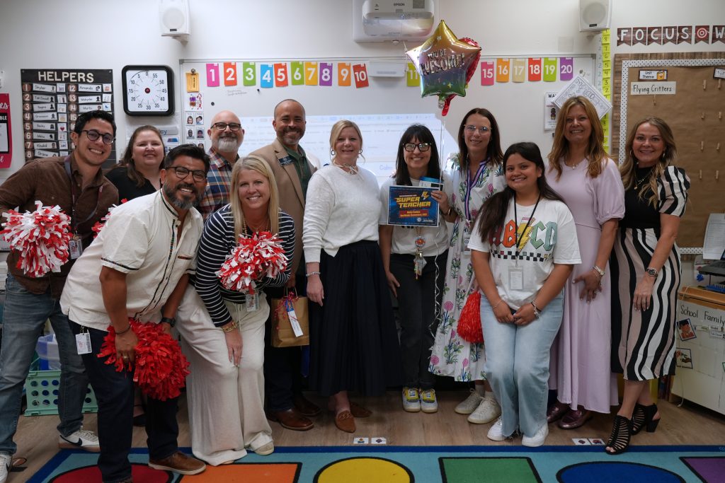 Super Teacher from Northlake Elementary Molly Fawkes posing with district and campus admin holding certificate and balloons