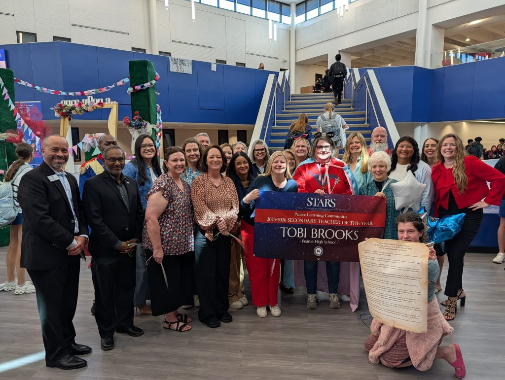 Tobi Brooks - PHS holding STARS teacher sign, big check, surrounded by prize patrol