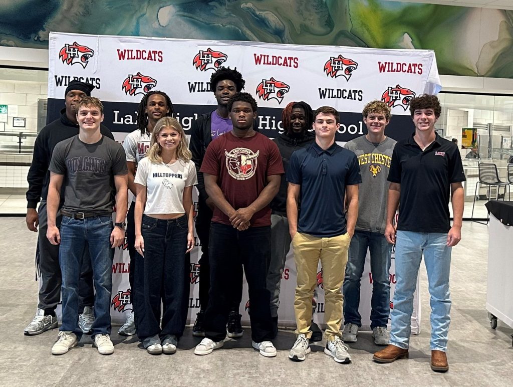 students standing in front of a LHHS step and repeat backdrop