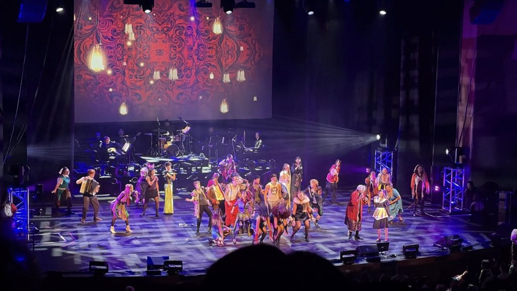 students in costume performing on stage