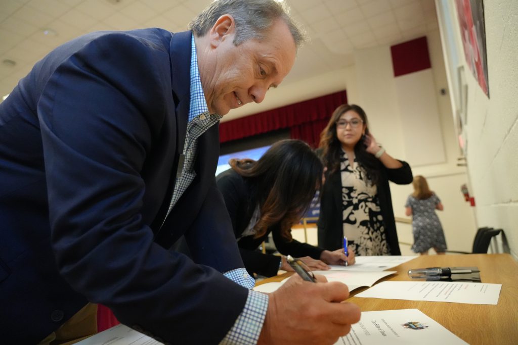 Man and woman signing papers