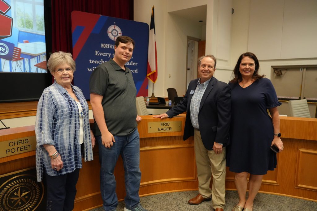 Eric Eager posing with family by with his name on it