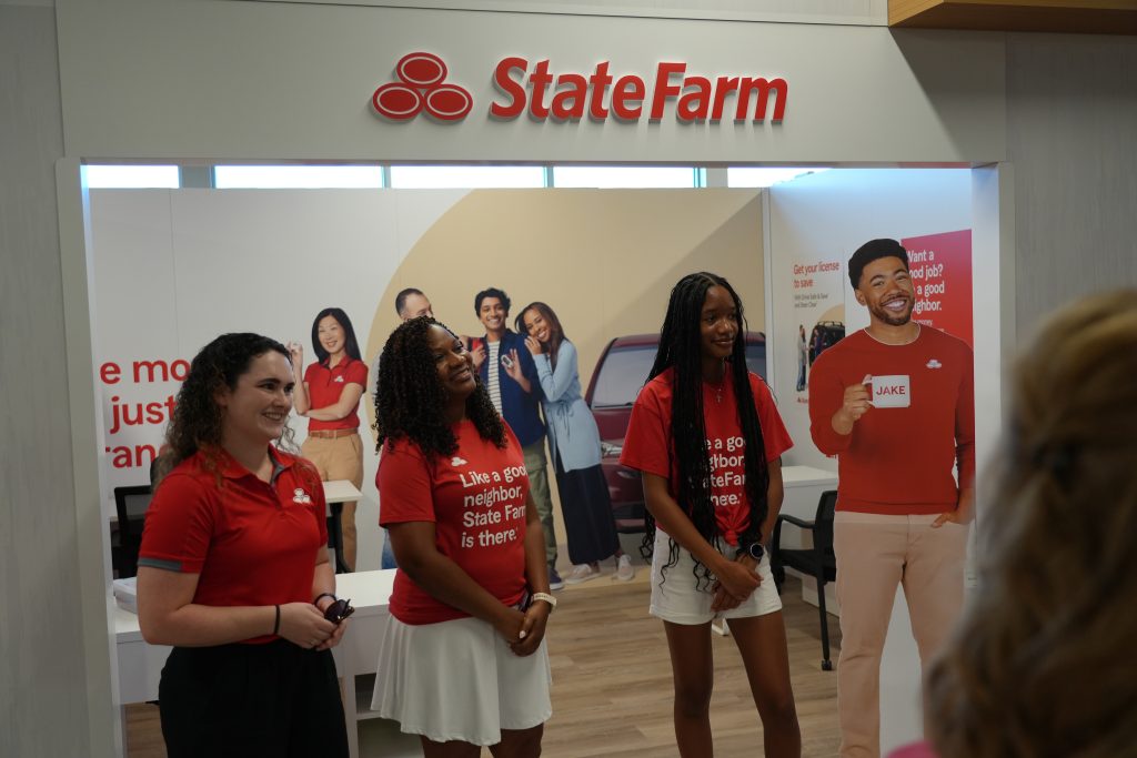 State Farm employees standing in front of the State Farm storefront