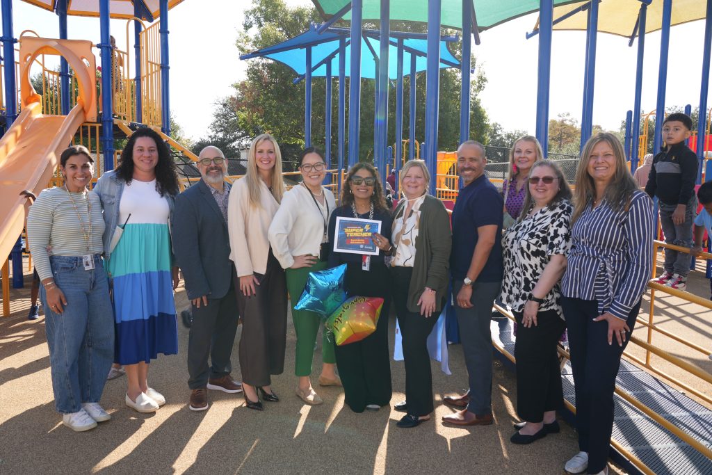Graciela Quintero, RISD Academy with district and campus admin holding super teacher award