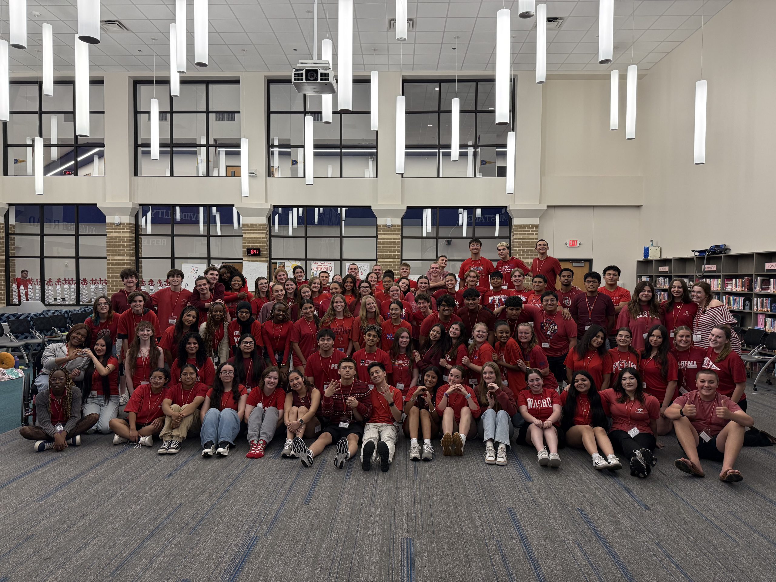 Group photo of 100+ SOS Lifeguard students wearing red shirts