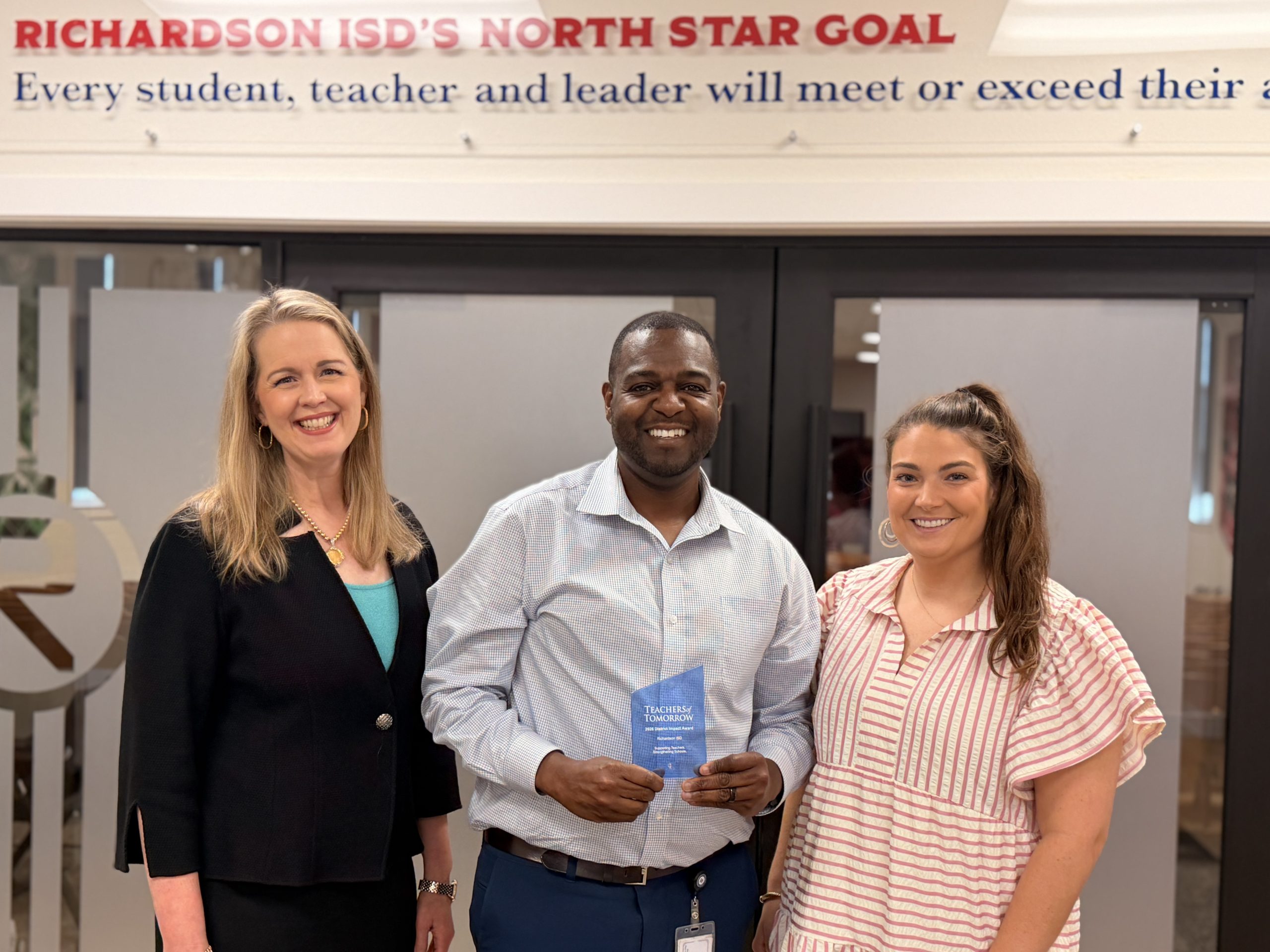 Vince Dawes holding Teachers of Tomorrow award with representatives