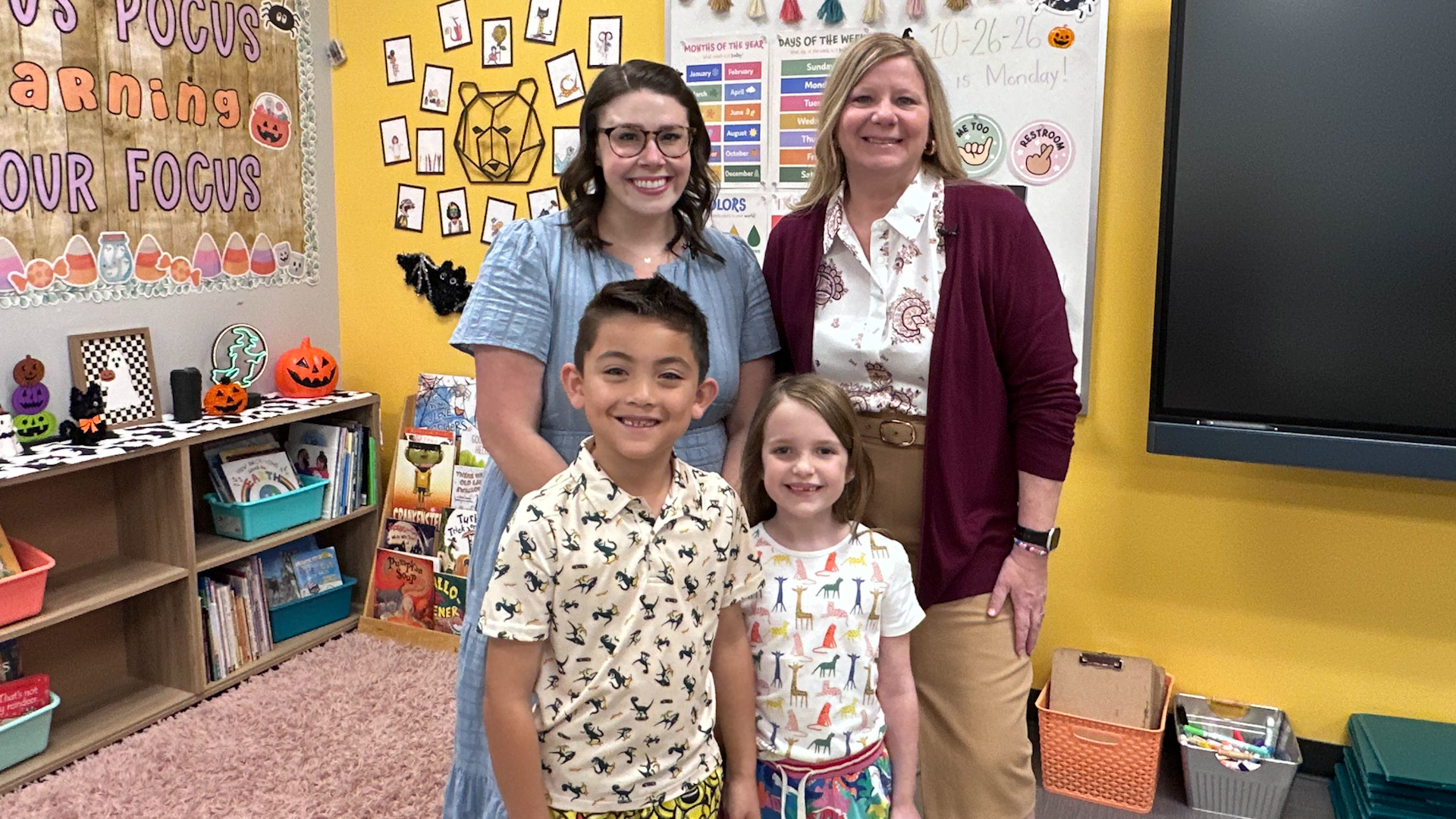 Superintendent Branum with teacher and two students in the classroom