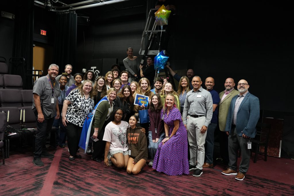 Madison Armstrong, Richardson High School with students, district, and campus admin as she holds Super Teacher Award and Balloons