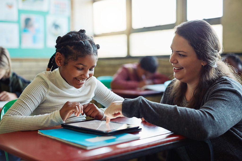 Teacher working with student tablet